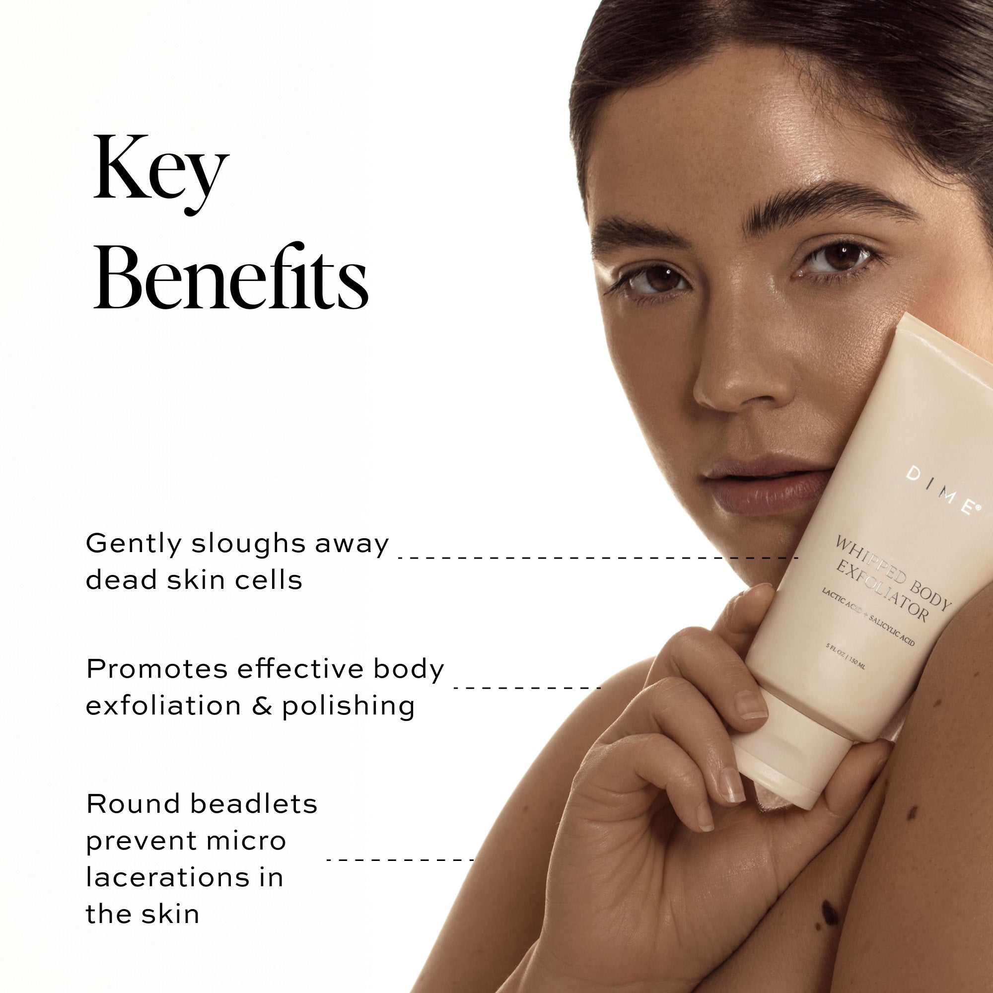 a woman holding a white tube of skincare product