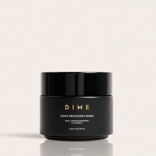 Black jar labeled "DIME Dewy Recovery Mask" with gold text, 3.38 fl oz size, on neutral background.