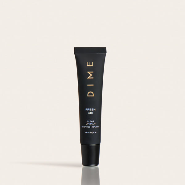 Black tube of DIME Fresh Air clear lip balm with gold lettering and black cap on neutral background.