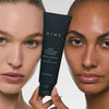 Black tube of Daily Exfoliating Cleanser held between two people with different skin tones showing facial results.