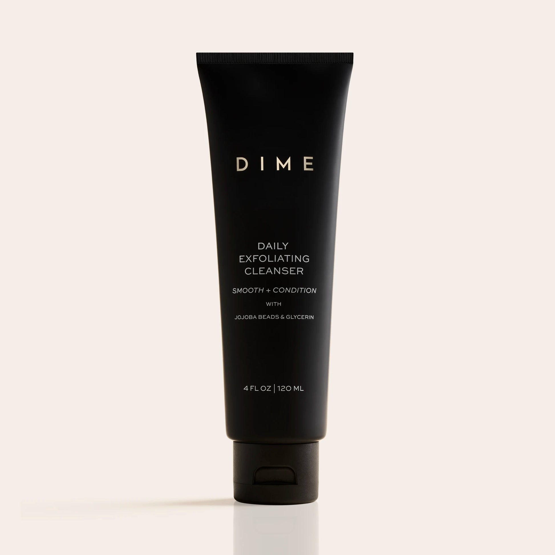 Black tube of DIME Daily Exfoliating Cleanser, 4 fl oz, with white text labeling on neutral background.
