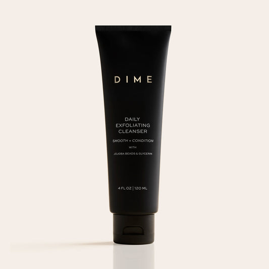 Black tube of DIME Daily Exfoliating Cleanser, 4 fl oz, with white text labeling on neutral background.