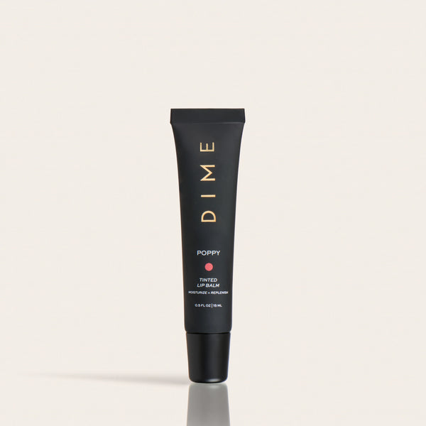 Black tube of Poppy tinted lip balm with gold text and cap, labeled 0.5 fl oz.