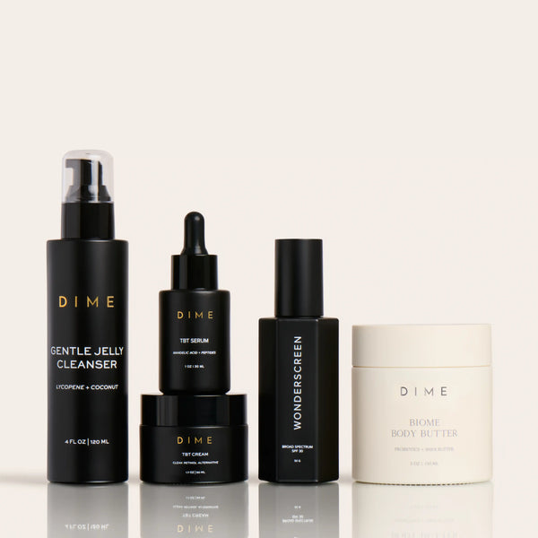 Four skincare products in black and cream containers: spray cleanser, serum, sunscreen, and body butter.