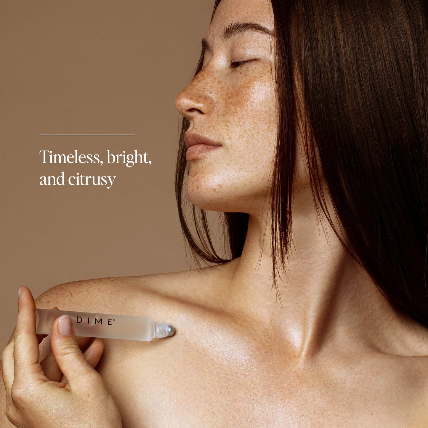 Woman holding a clear cylindrical Core Memory Roller product against her shoulder.