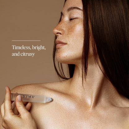 Woman holding a clear cylindrical Core Memory Roller product against her shoulder.