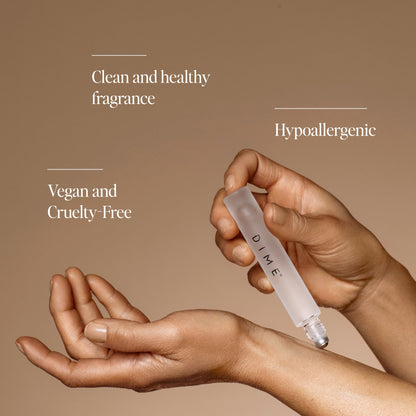 Two hands holding a white roller pen labeled "DIME" against a beige background with text about fragrance benefits.